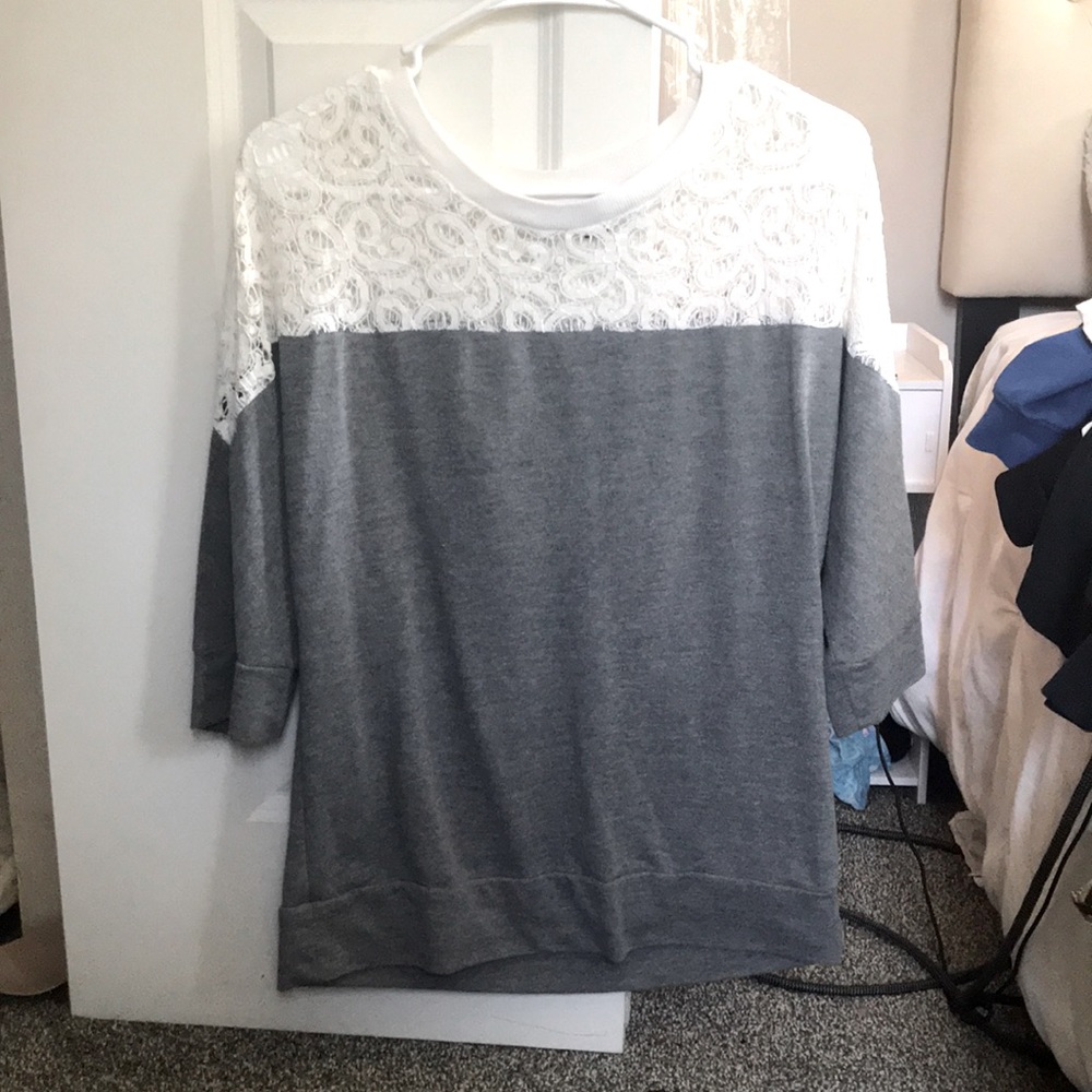 half sleeved shirt. see through design at top. gray on bottom. size small. Ana